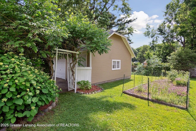 6244 Daft St, Lansing, MI 48911 - view of property exterior featuring a lawn and a vegetable garden
