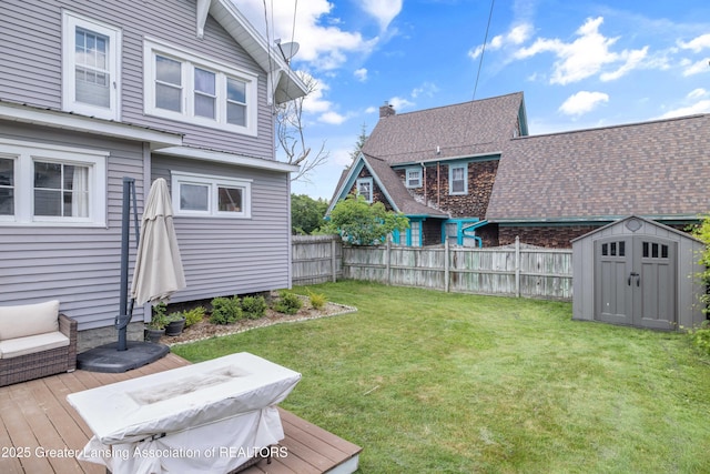 308 Memphis St, Lansing, MI 48915 - fenced backyard with a storage unit and a deck
