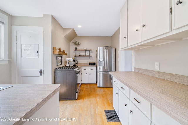 308 Memphis St, Lansing, MI 48915 - kitchen with appliances with stainless steel finishes, light countertops, white cabinets, and recessed lighting
