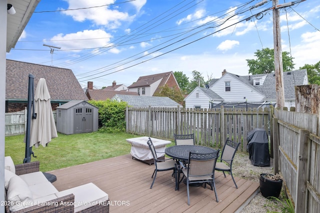 308 Memphis St, Lansing, MI 48915 - deck with a shed, outdoor dining area, a fenced backyard, and a grill