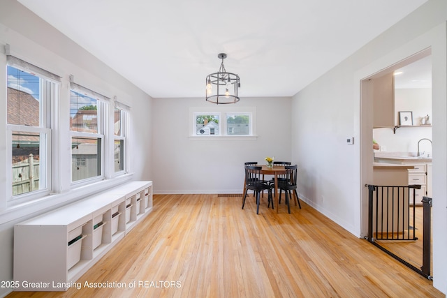 308 Memphis St, Lansing, MI 48915 - dining area featuring light wood-type flooring, plenty of natural light, and a chandelier