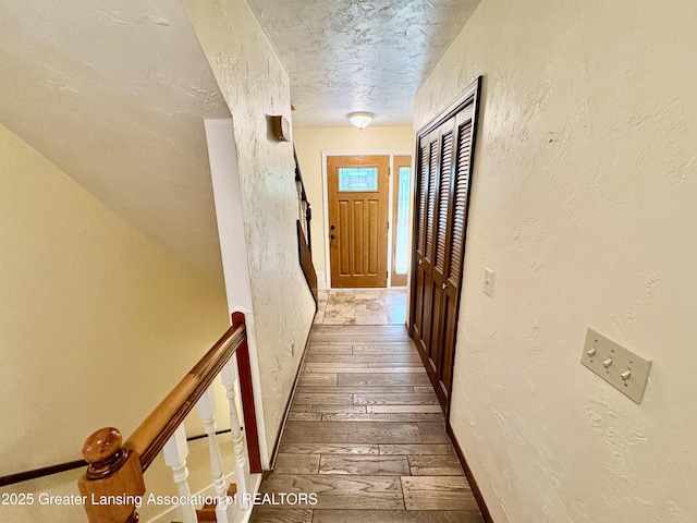 12830 Upton Rd, Bath, MI 48808 - hall with hardwood / wood-style floors, a textured wall, and a textured ceiling