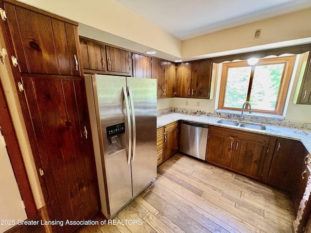 12830 Upton Rd, Bath, MI 48808 - kitchen with stainless steel appliances, light wood-style flooring, and light stone countertops