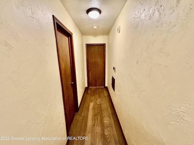 12830 Upton Rd, Bath, MI 48808 - corridor with dark wood finished floors and a textured wall