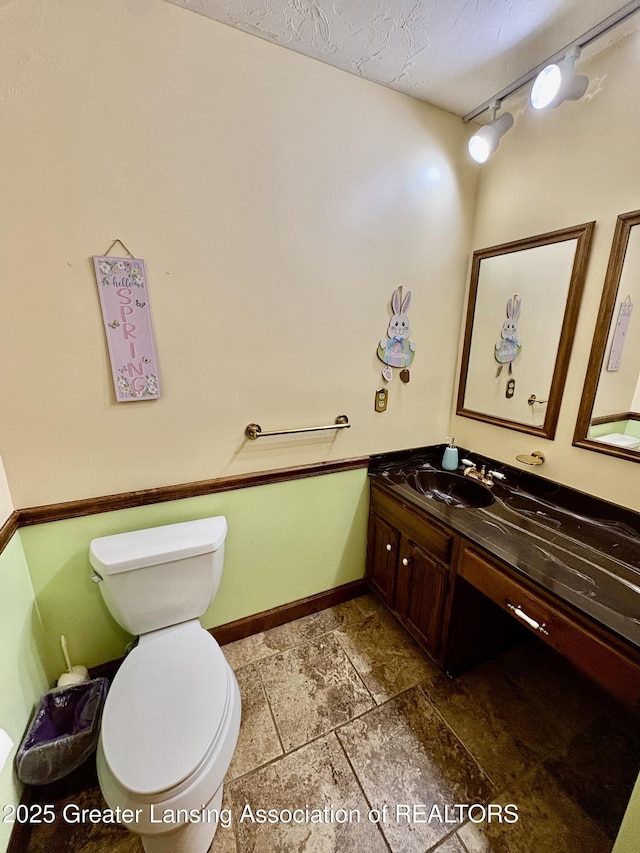 12830 Upton Rd, Bath, MI 48808 - bathroom featuring vanity, stone tile flooring, and a textured ceiling