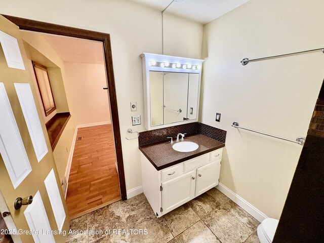 12830 Upton Rd, Bath, MI 48808 - bathroom featuring vanity and decorative backsplash