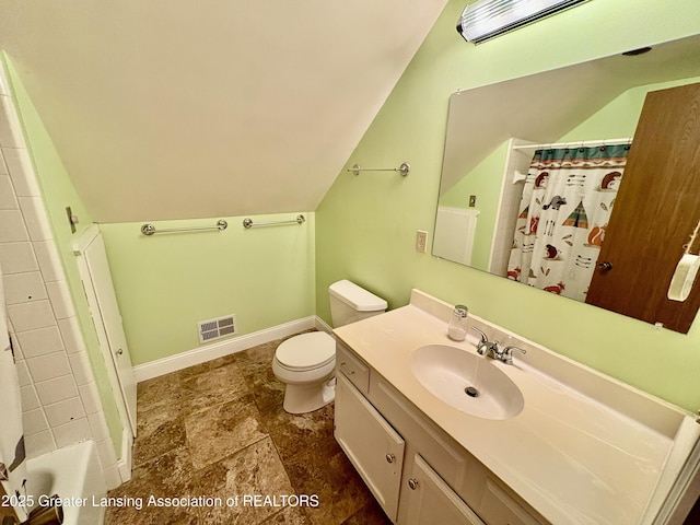 12830 Upton Rd, Bath, MI 48808 - bathroom featuring vaulted ceiling, vanity, and stone finish flooring