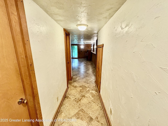 12830 Upton Rd, Bath, MI 48808 - corridor with light stone finish flooring and a textured wall