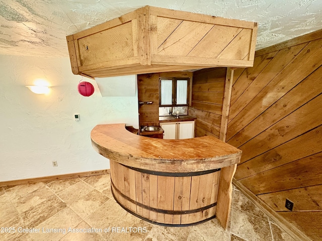 12830 Upton Rd, Bath, MI 48808 - indoor bar featuring light stone finish flooring and wooden walls