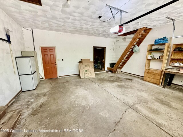 12830 Upton Rd, Bath, MI 48808 - garage featuring a garage door opener