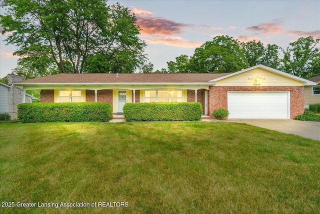 10648 Bobsyl Ln, Grand Ledge, MI 48837 - ranch-style house featuring a front lawn, an attached garage, concrete driveway, and brick siding