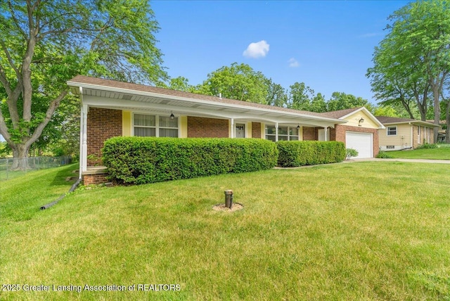 10648 Bobsyl Ln, Grand Ledge, MI 48837 - view of front facade with a garage and brick siding