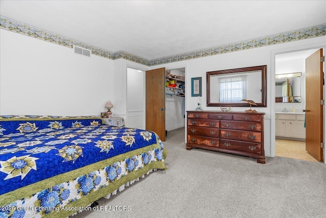 10648 Bobsyl Ln, Grand Ledge, MI 48837 - bedroom with carpet, a spacious closet, a closet, and ensuite bathroom