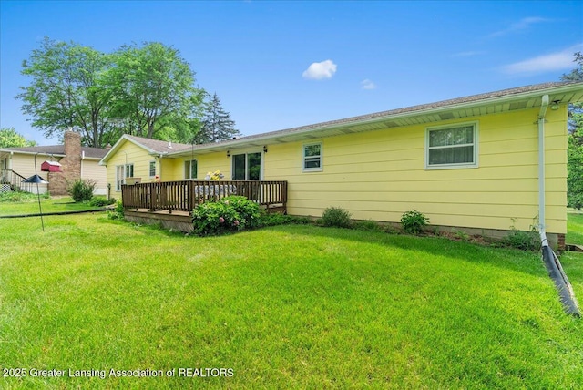 10648 Bobsyl Ln, Grand Ledge, MI 48837 - back of property with a deck and a yard