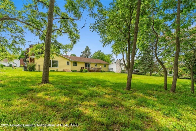 10648 Bobsyl Ln, Grand Ledge, MI 48837 - view of grassy yard with a wooden deck