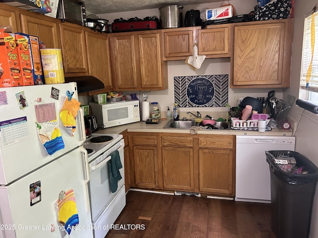 410 W Maple St, Lansing, MI 48906 - kitchen featuring white appliances, light countertops, dark wood finished floors, and brown cabinetry