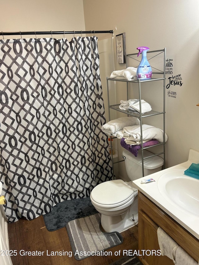 410 W Maple St, Lansing, MI 48906 - bathroom with a shower with shower curtain, vanity, and wood finished floors
