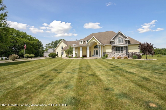 5056 W Bunker Rd, Mason, MI 48854 - craftsman-style house with stone siding and a front lawn