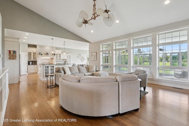 5056 W Bunker Rd, Mason, MI 48854 - living area with a chandelier, light wood-style flooring, recessed lighting, and high vaulted ceiling