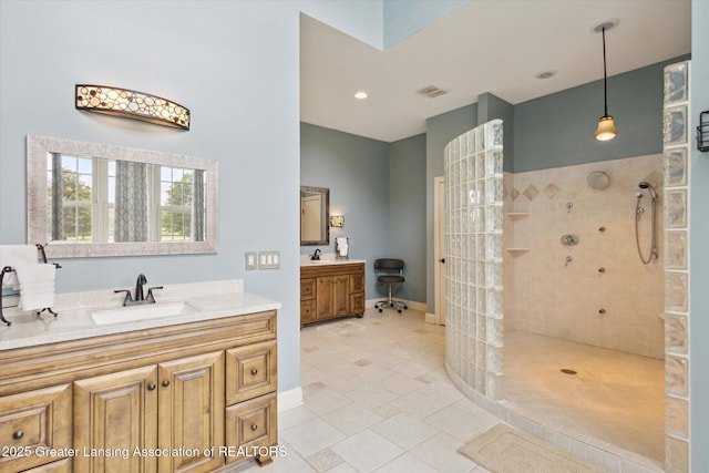5056 W Bunker Rd, Mason, MI 48854 - full bathroom featuring a walk in shower, two vanities, and tile patterned flooring