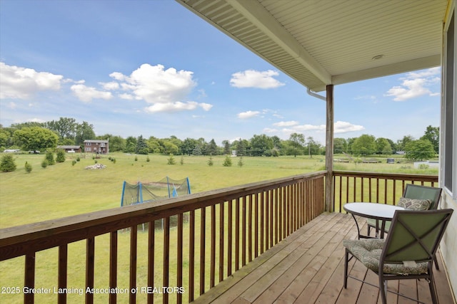 5056 W Bunker Rd, Mason, MI 48854 - wooden deck featuring a view of countryside, a lawn, and view of scattered trees