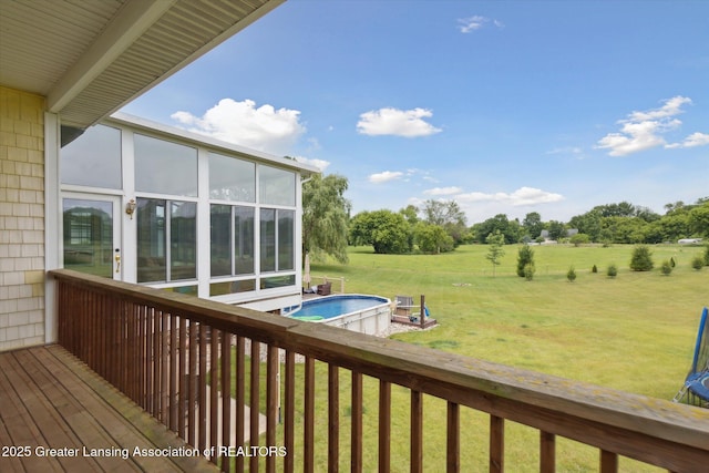 5056 W Bunker Rd, Mason, MI 48854 - wooden deck with a sunroom, an outdoor pool, a yard, and a view of countryside