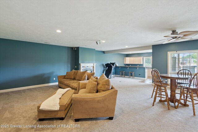 5056 W Bunker Rd, Mason, MI 48854 - living area featuring carpet floors, a ceiling fan, recessed lighting, and a textured ceiling