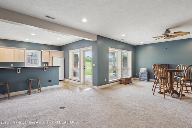 5056 W Bunker Rd, Mason, MI 48854 - dining area featuring light carpet, recessed lighting, a textured ceiling, and a ceiling fan