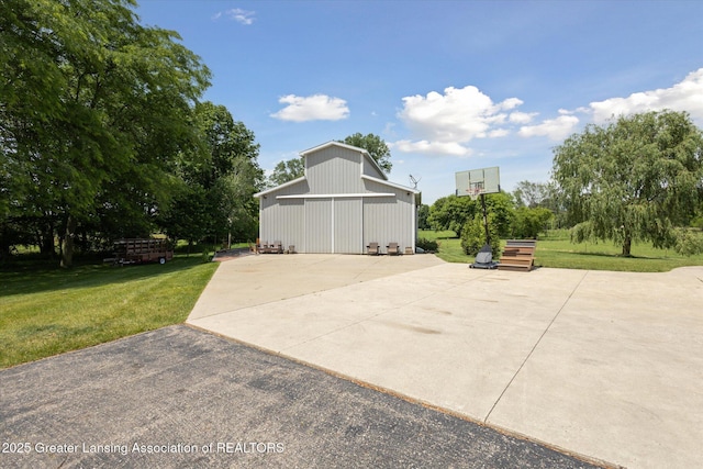 5056 W Bunker Rd, Mason, MI 48854 - view of patio with a detached garage, a barn, and an outdoor structure