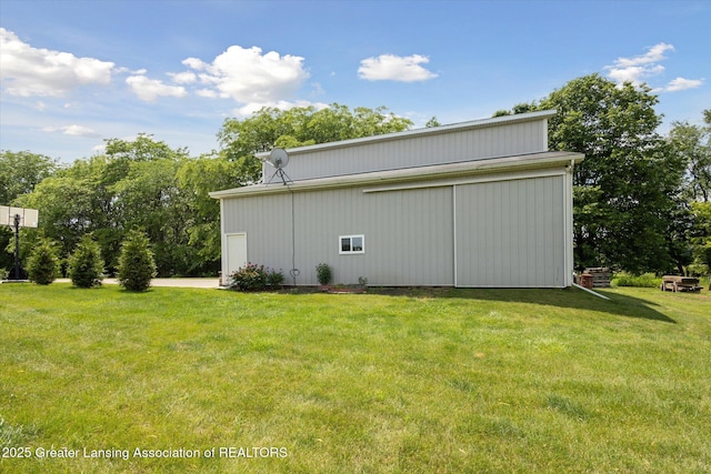 5056 W Bunker Rd, Mason, MI 48854 - view of home's exterior featuring a lawn, an outdoor structure, and a pole building