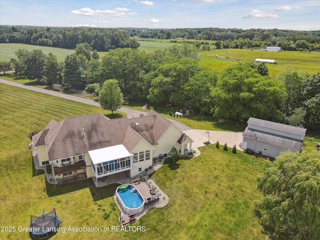 5056 W Bunker Rd, Mason, MI 48854 - view of rural area featuring a pool area and a tree filled landscape