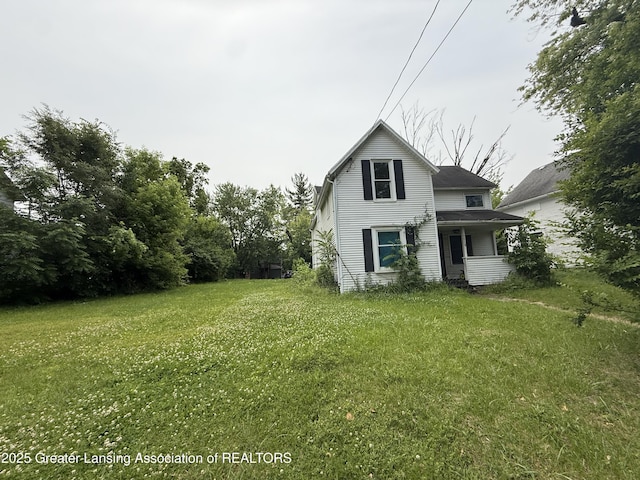 1018 E Kalamazoo St, Lansing, MI 48912 - view of side of property featuring a lawn and covered porch