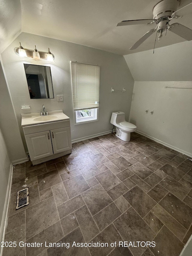 1018 E Kalamazoo St, Lansing, MI 48912 - bathroom featuring vaulted ceiling, vanity, ceiling fan, and stone finish flooring