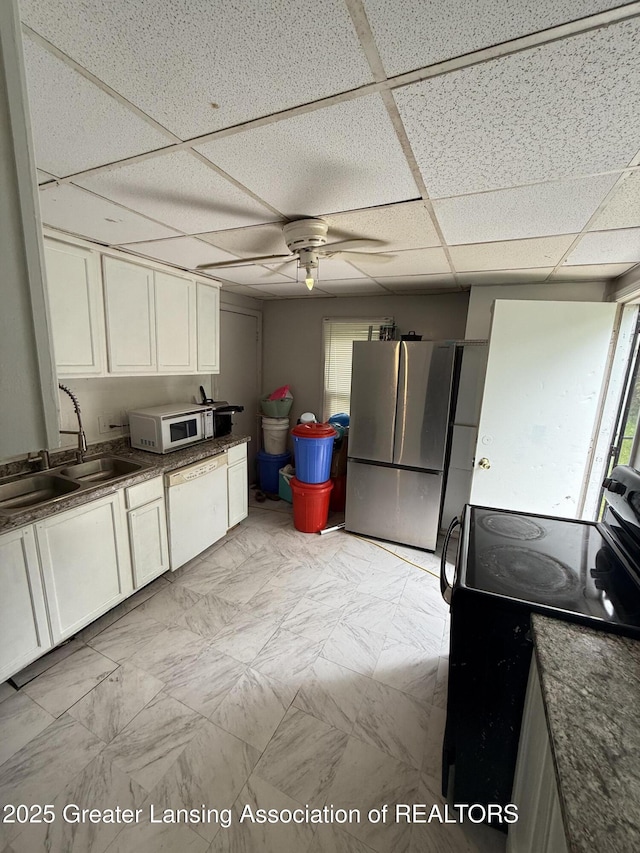 1018 E Kalamazoo St, Lansing, MI 48912 - kitchen with black electric range, white dishwasher, freestanding refrigerator, a drop ceiling, and ceiling fan
