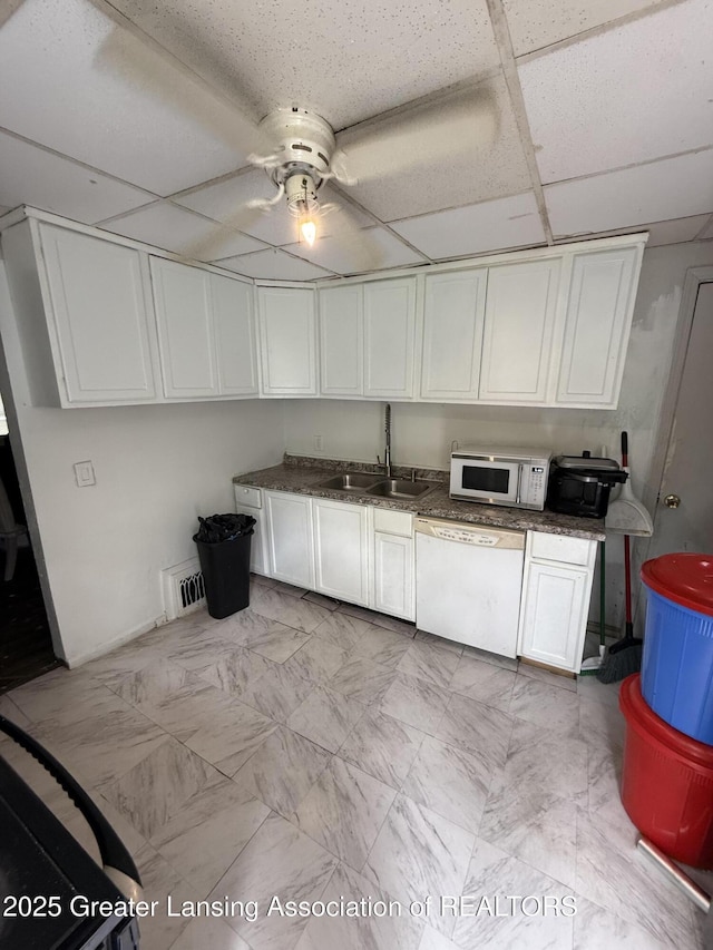 1018 E Kalamazoo St, Lansing, MI 48912 - kitchen with white appliances, ceiling fan, a drop ceiling, white cabinets, and dark countertops