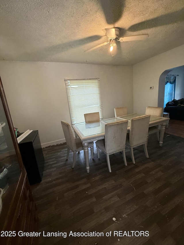 1018 E Kalamazoo St, Lansing, MI 48912 - dining room with dark wood-type flooring, a ceiling fan, arched walkways, and a textured ceiling