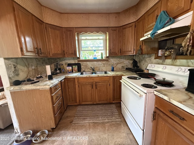 4317 S Cedar St, Lansing, MI 48910 - kitchen with white electric stove, light countertops, and decorative backsplash