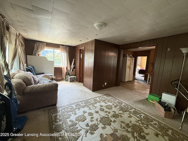 4317 S Cedar St, Lansing, MI 48910 - living area with wooden walls and light colored carpet