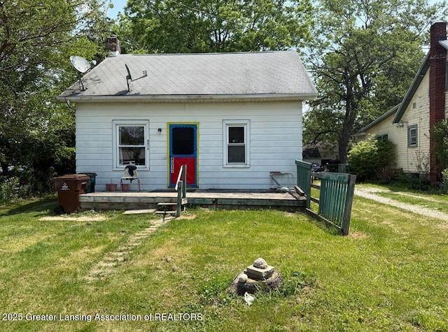4317 S Cedar St, Lansing, MI 48910 - rear view of property with a yard and a chimney