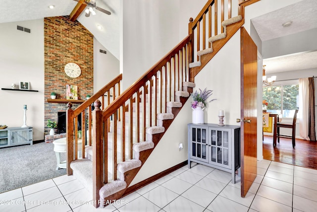 5925 Cabrena Dr, Lansing, MI 48917 - stairs featuring high vaulted ceiling, beam ceiling, tile patterned floors, a fireplace, and a chandelier