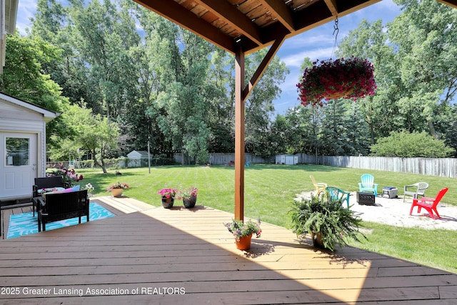 5925 Cabrena Dr, Lansing, MI 48917 - wooden terrace with an outdoor fire pit, a fenced backyard, and a patio