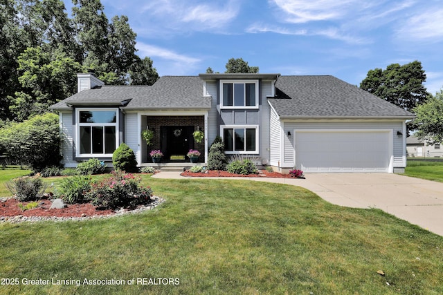 5925 Cabrena Dr, Lansing, MI 48917 - view of front of home with an attached garage, a chimney, concrete driveway, a front lawn, and a shingled roof
