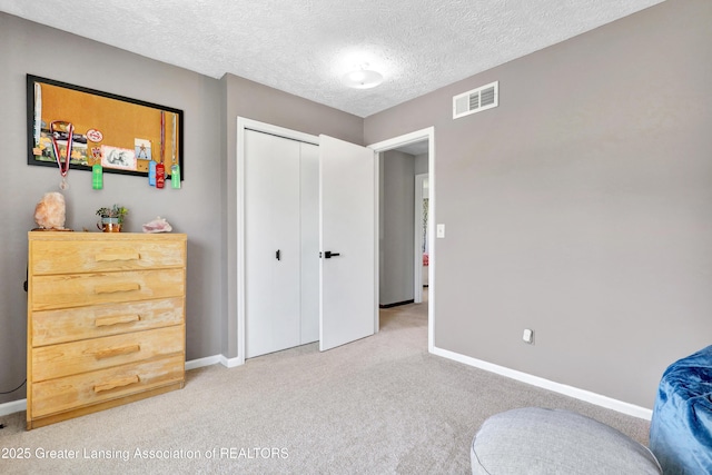 5925 Cabrena Dr, Lansing, MI 48917 - bedroom with carpet floors, a closet, and a textured ceiling