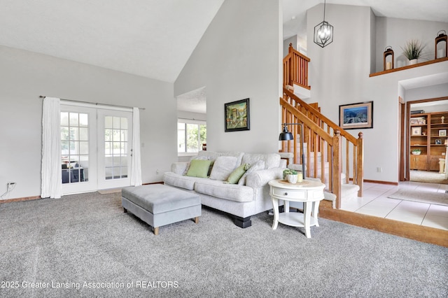 5925 Cabrena Dr, Lansing, MI 48917 - carpeted living room featuring high vaulted ceiling, stairway, and french doors