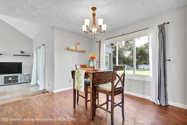 5925 Cabrena Dr, Lansing, MI 48917 - dining space with a chandelier, wood finished floors, a textured ceiling, and lofted ceiling