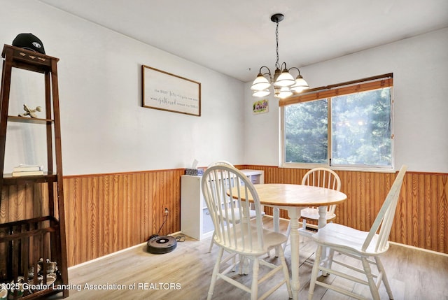 314 Scarlet Oak Ln, Perry, MI 48872 - dining space featuring a wainscoted wall, wood finished floors, wooden walls, and a chandelier