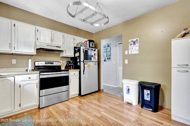 314 Scarlet Oak Ln, Perry, MI 48872 - kitchen featuring electric stove, freestanding refrigerator, under cabinet range hood, white cabinets, and light countertops