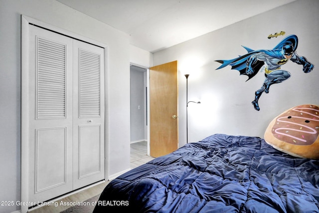 314 Scarlet Oak Ln, Perry, MI 48872 - bedroom with a closet and light wood finished floors