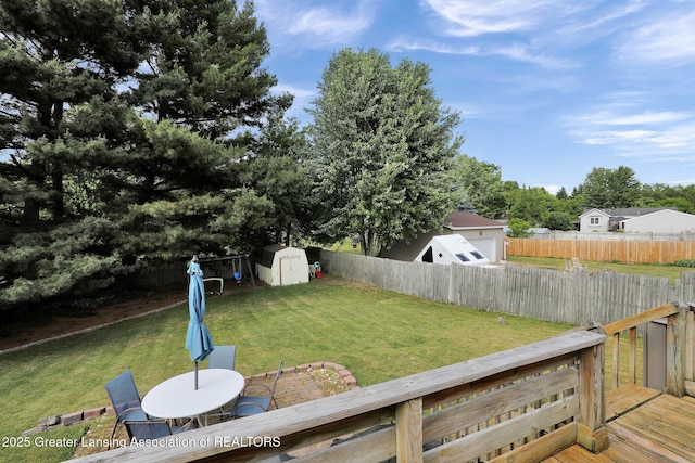 314 Scarlet Oak Ln, Perry, MI 48872 - fenced backyard featuring a storage shed, outdoor dining space, and a deck