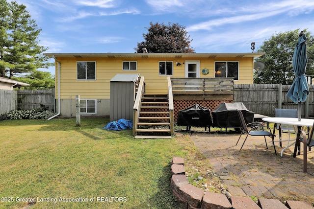 314 Scarlet Oak Ln, Perry, MI 48872 - rear view of property featuring a deck, a fenced backyard, a patio area, outdoor dining area, and stairs